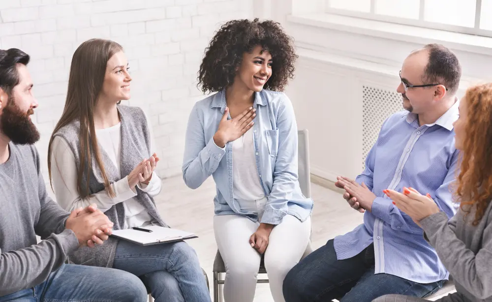 Five people in a group therapy session.