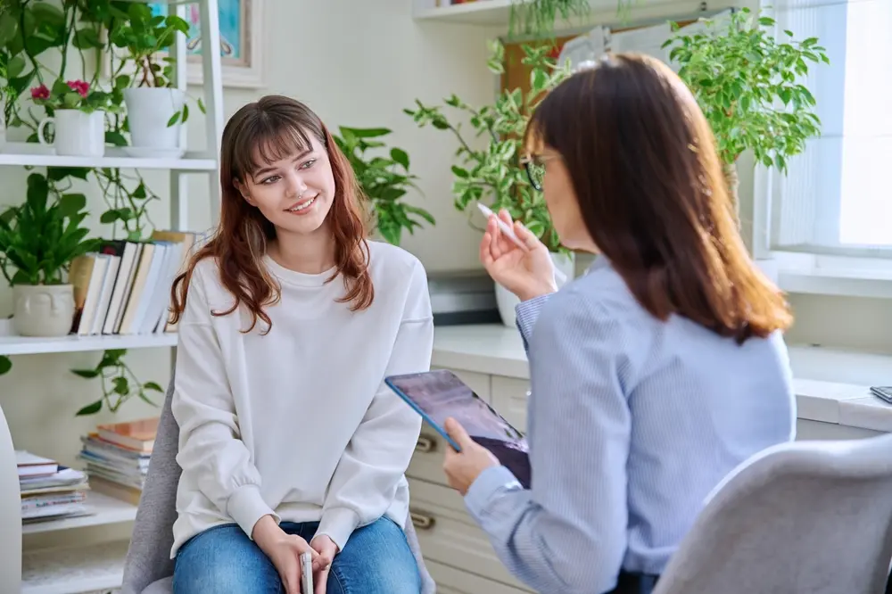 A therapist working with a teen.